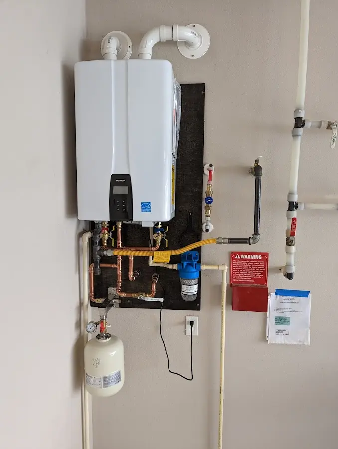 Professional plumber installing copper piping in a National City home